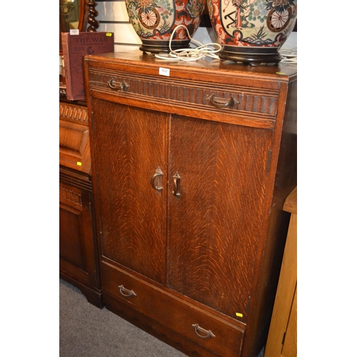 1032 - Tall oak cupboard with lower and upper drawer and internal shelves W76 x D47 x H123cm