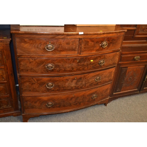 1039 - Two over three bow fronted flame mahogany veneer chest of drawers W108 x D54 x H103cm