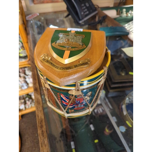 605A - Devon & Dorset Regiment coat of arms ice bucket modelled as drum, height 17cm, together with a D... 