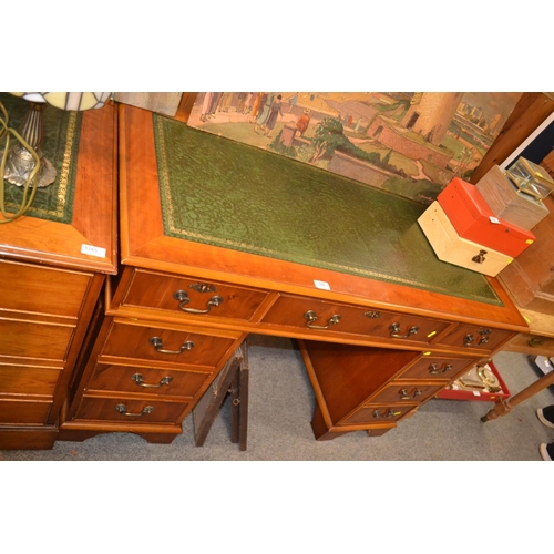 1164 - Knee whole leather topped desk with nine drawers.