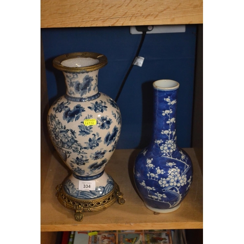 334 - Two oriental style vases, one with gilt trim and stand, tallest 36cm