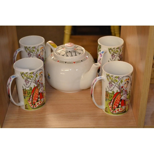 377 - Alice in Wonderland teapot and four mugs by Paul Cardew