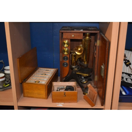 404 - Brass microscope in a wooden purpose made case plus individual box of zoo slides and some bottony.