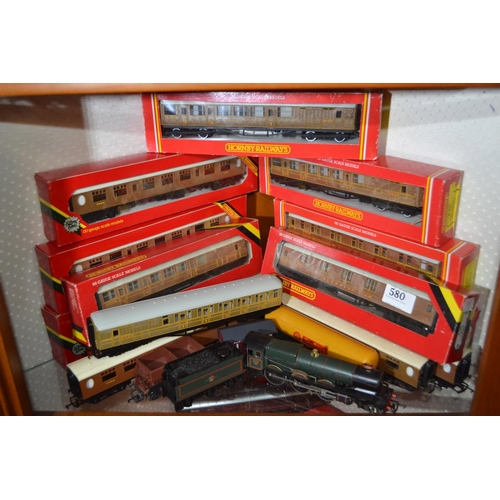 580 - Shelf full of mainly Hornby 00 gauge rolling stock and some engines.