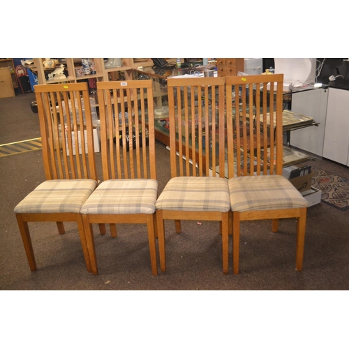 673 - Four modern oak dining chairs, tartan seat covers.