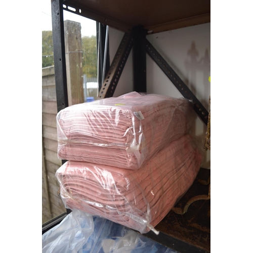 100 - 2 new packs of pink bath mats/towels. Appear to be small size, 12 in each pack