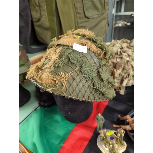 269 - Large quantity of assorted military clothing inc. flack jacket, four helmets, two hats and a wool gr... 