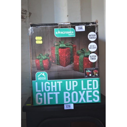 186 - Light up LED gift boxes gold with red bows.