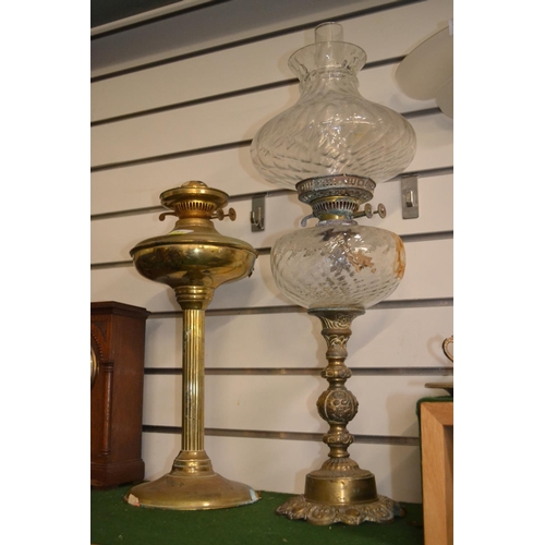 334 - Two oil lamps, one brass with no chimney or shade the other with glass reservoir, shade and chimney ... 