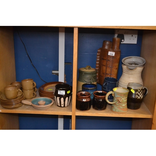 336 - Two shelves of studio pottery, some signed