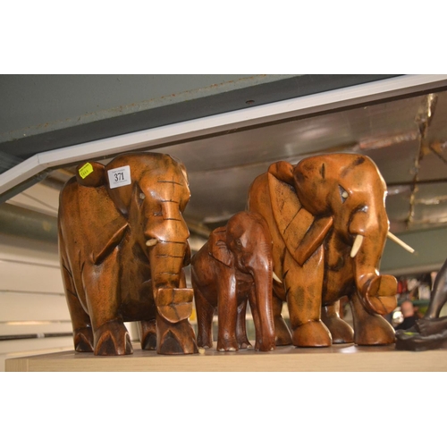 371 - 3 carved wooden elephants, Tallest 24cm high. 