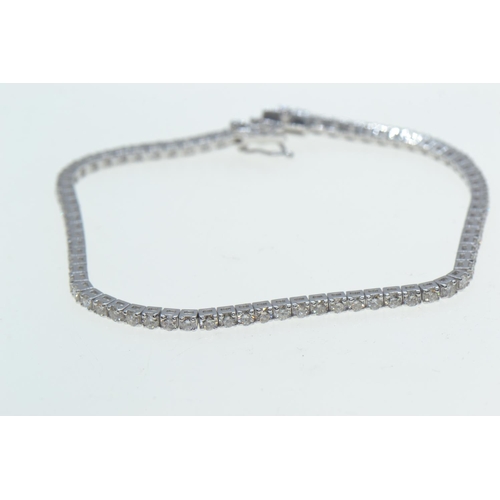 32 - 18ct white gold & diamond line bracelet, set with seventy-four brilliant-cut diamonds together w... 