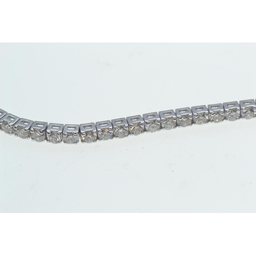 32 - 18ct white gold & diamond line bracelet, set with seventy-four brilliant-cut diamonds together w... 