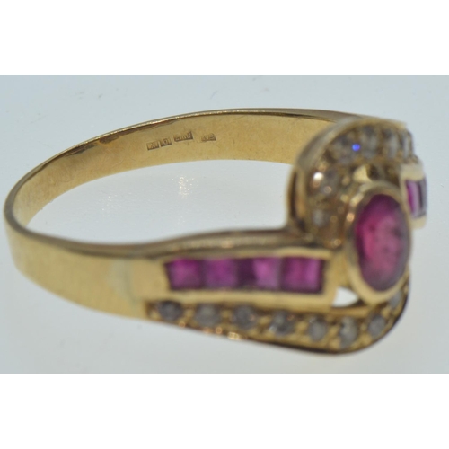 47 - 18ct gold, ruby & diamond crossover ring, the central bezel-set ruby measuring approximately 5.5... 