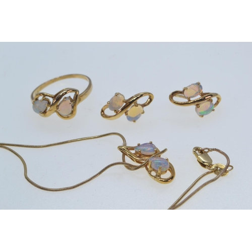 87 - Opal parure, comprising: a pendant on a 9ct gold chain; a ring, size Q, and a pair of earrings (no b... 