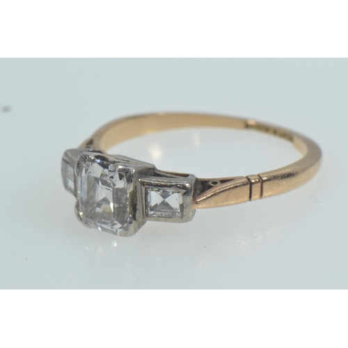 113 - 18ct gold, platinum & emerald-cut diamond trilogy ring, the centre stone weighing approximately ... 