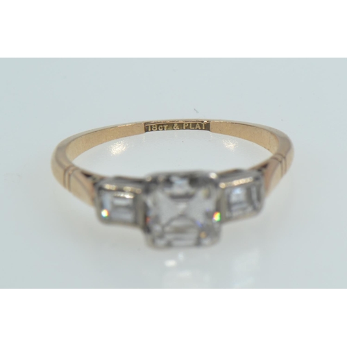 113 - 18ct gold, platinum & emerald-cut diamond trilogy ring, the centre stone weighing approximately ... 