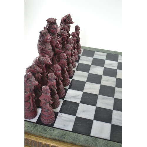 299 - Resin Reynard the Fox inspired chess pieces, together with Compton and Woodhouse marble chess board,... 