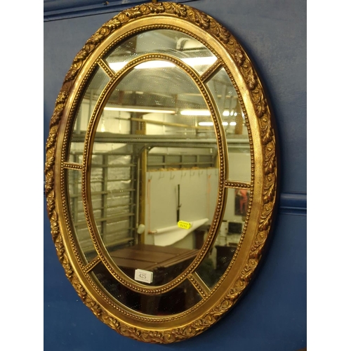 425 - Gilt framed oval mirror with mirrored border, 67.5 x 53cm