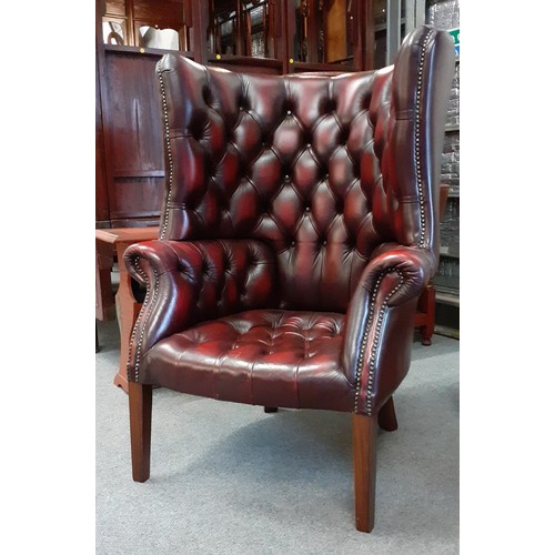 529 - Oxblood barrel backed Chesterfield library armchair W80cm H112cm with footstool W68cm D51cm H30cm.