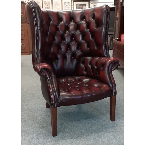 529 - Oxblood barrel backed Chesterfield library armchair W80cm H112cm with footstool W68cm D51cm H30cm.