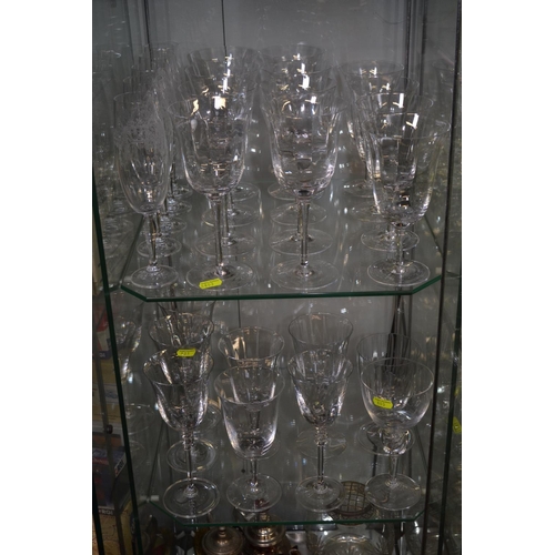 666 - 2 shelves of wine glasses & champagne flutes, all American Fosteria Crystal glasses.