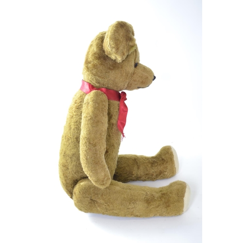 1023 - Large early C20th mohair teddy bear, wood wool stuffed with articulated limbs, approx 70cm length