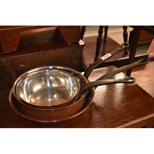 1137 - Three Bourgeat stainless steel lined copper pans; two shallow pans and a frying pan, 20, 24 and 28