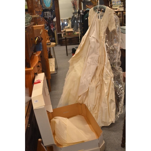 1151 - Ivory coloured wedding dress and train in box.