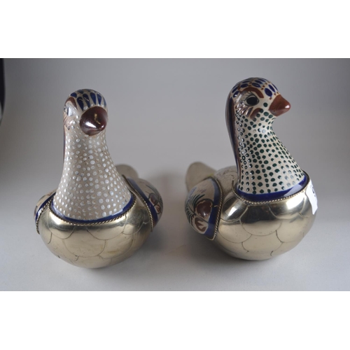 904 - White metal & ceramic decorated doves. 20cm long x 15cm high.