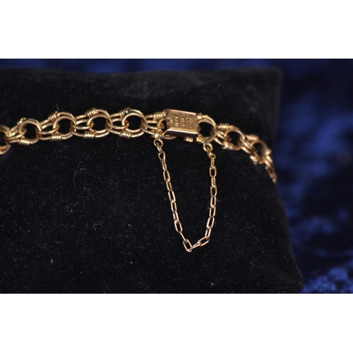 398 - 18ct gold triple link bracelet, with safety chain, circumference 200mm, gross weight 23.2 grams