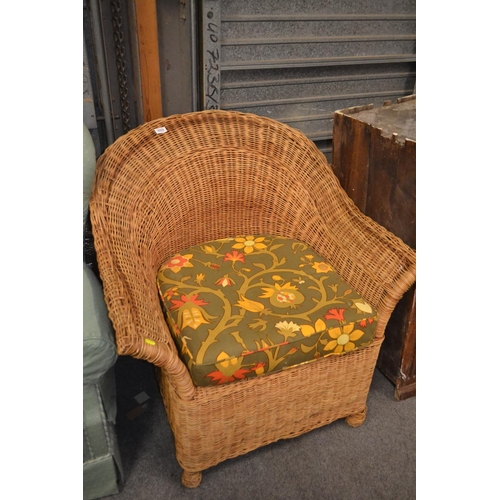 102 - Wicker conservatory armchair with floral cushion