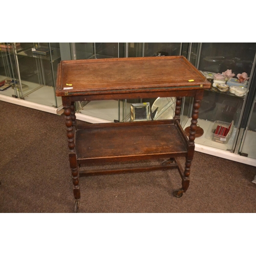 308 - Folding card table with one shelf, appears to have original castors. W 69 x D 36 H 74CM