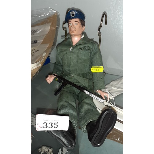 335 - Vintage action man figure, including some uniforms and other accessories.