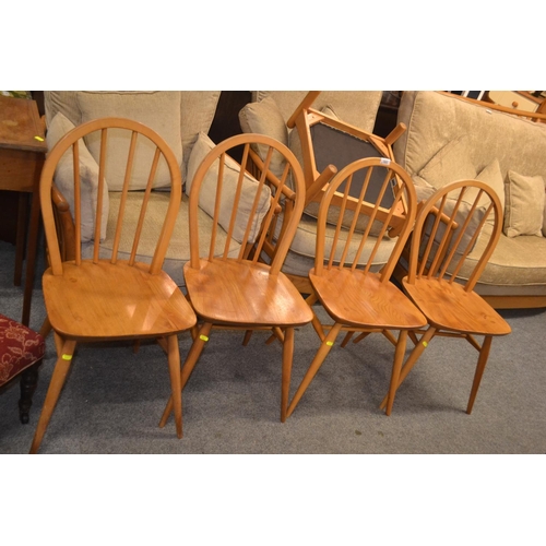 593 - Four blonde Ercol dining chairs, stamps to some chairs clearly marked.