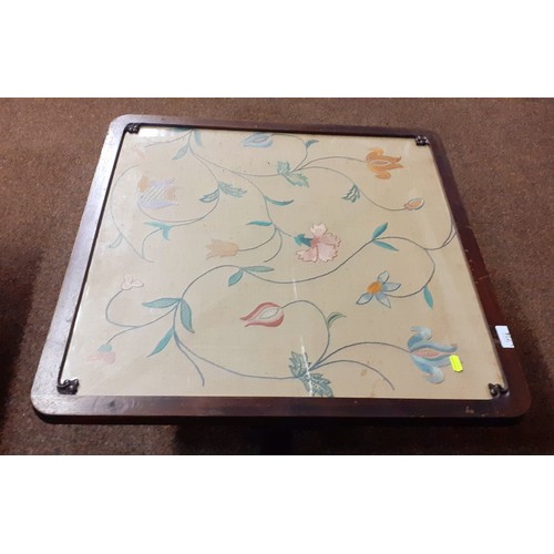 274 - Foldable fire screen with embroidered front behind glass with wooden surround and base.