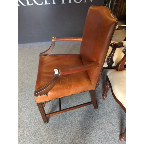 625 - Large leather upholstered arm/elbow chair with studded finish to edging.