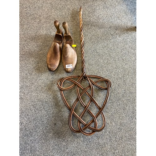 626A - A pair of wooden shoe lasts/shape holders and a cane carpet beater.