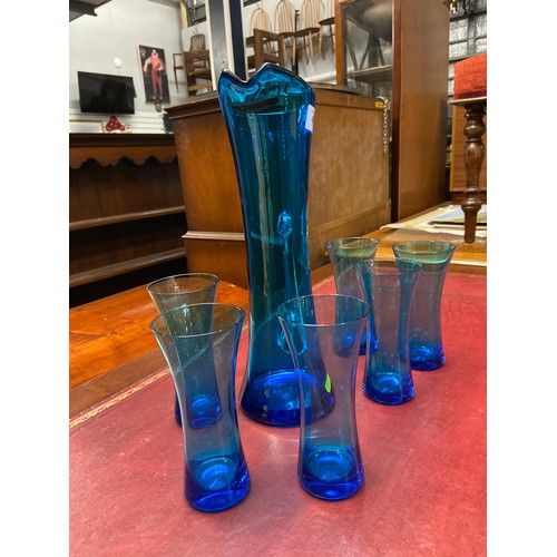 621 - Hand blown kingfisher blue glass elegant jug (35.5cm height) and six glass set. Thought to be Whitef... 