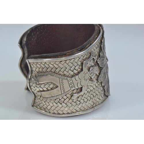 414 - Native American Navajo white metal cuff, the front with applied native American chief flanked by a n... 