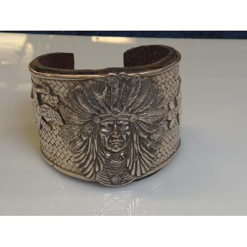 414 - Native American Navajo white metal cuff, the front with applied native American chief flanked by a n... 