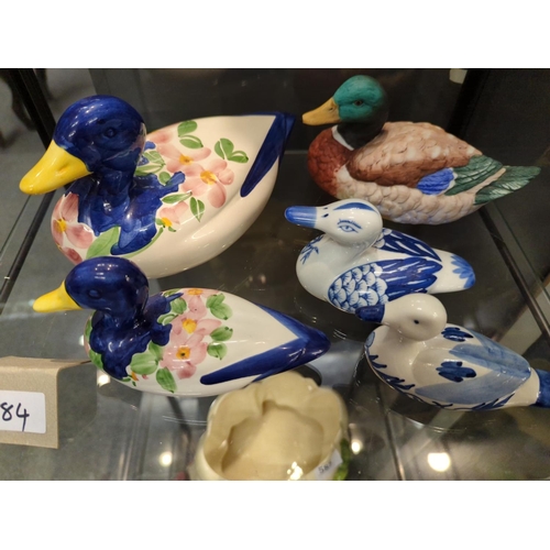 584 - Collection of duck ornaments over two shelves, inc. Beswick pin dish (with repair) and others