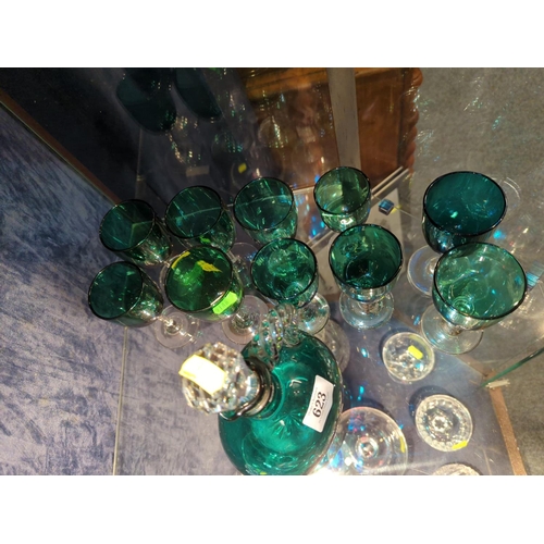 623 - Green glass decanter with 10 stemmed glasses.