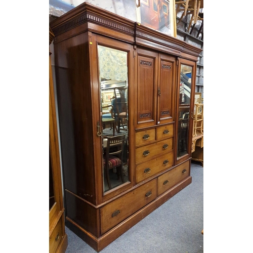 654 - Early C20 large compactum wardrobe, with 2 mirror fronted doors flanking central unit comprised of 2... 