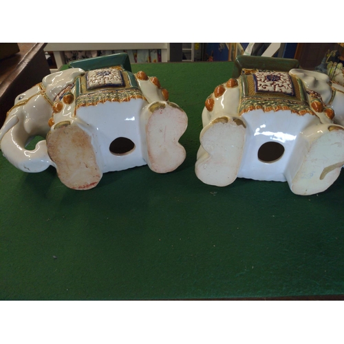 294 - Pair of ceramic elephant plant stands in green blue and white. H 27 L 31 cm approx.