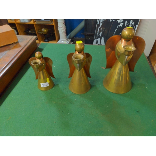 320 - Three graduated candle holding angels in brass and copper . H 29cm of largest.