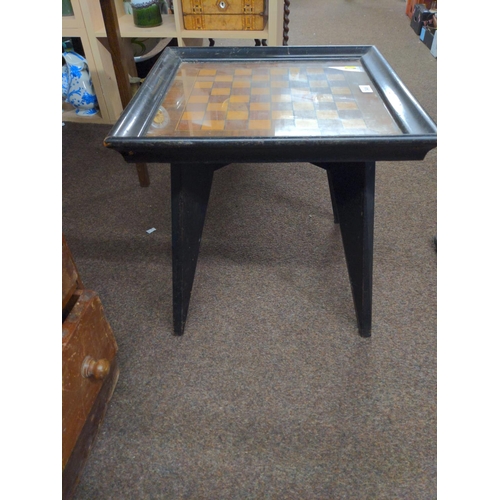 348 - Glass topped chess board/table. Ebonised wood. W 5 D 50 H 49 cm