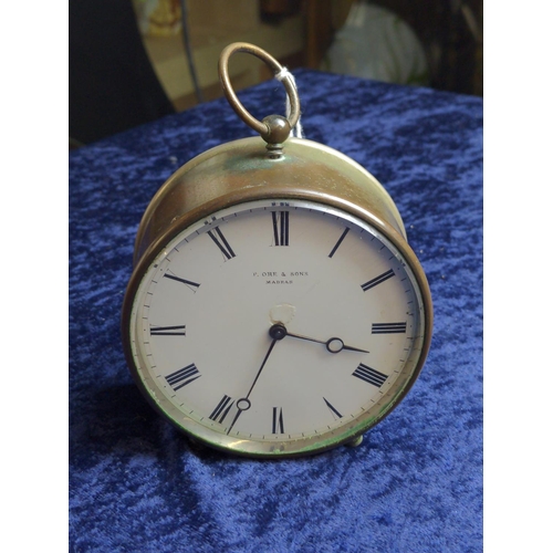 391 - French V.A.P Brevete drum clock retailed by P. Ore & Sons Madras, with key, diameter 9.5cm