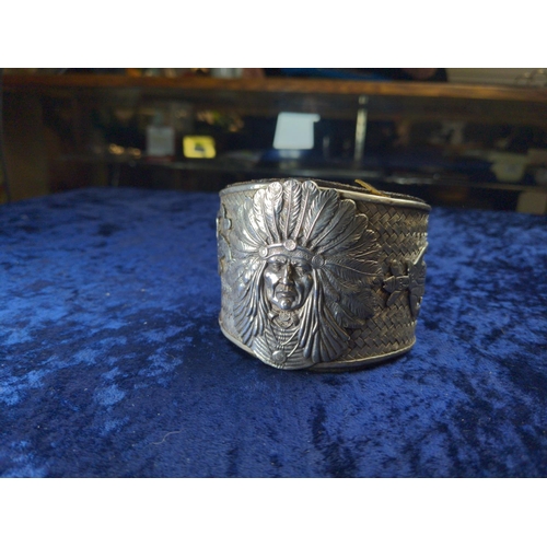 414 - Native American Navajo white metal cuff, the front with applied native American chief flanked by a n... 