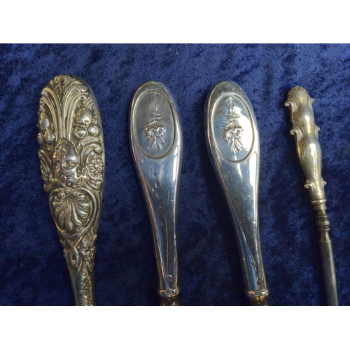 443 - Three hallmarked silver handled button hooks & a hallmarked silver handled shoe horn matching on... 